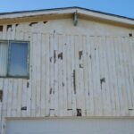 Peeling exterior paint on wood siding before preparation in San Diego