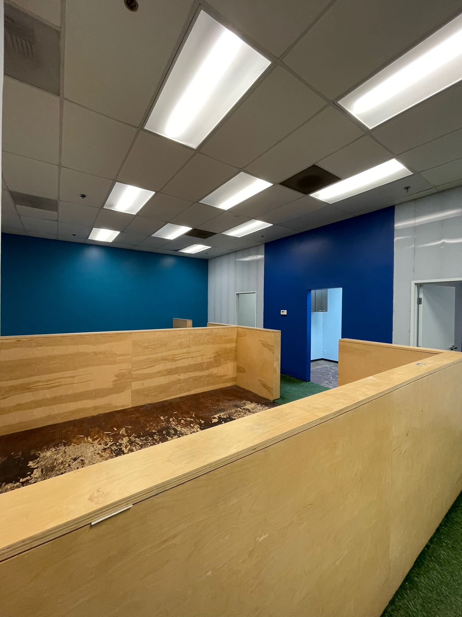 Interior with a deep blue accent wall and a newly built wood reception counter