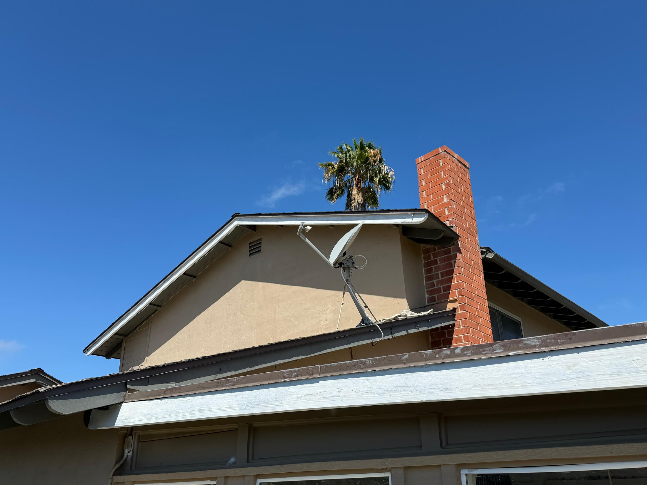 Existing gutters and exposed fascia on a San Diego home before exterior preparation