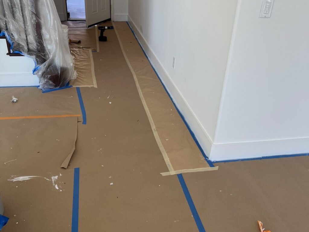Rosin paper taped over flooring during an interior painting project